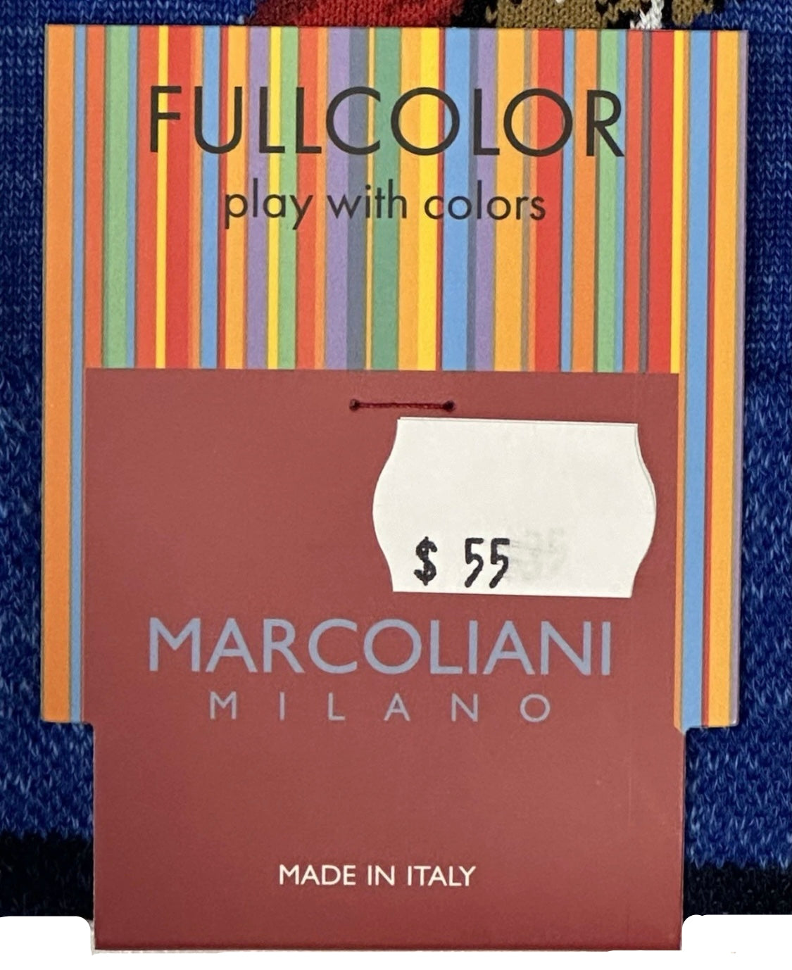 Marcolianidi Milano product packaging with colorful top section and brown bottom section, featuring a price tag.